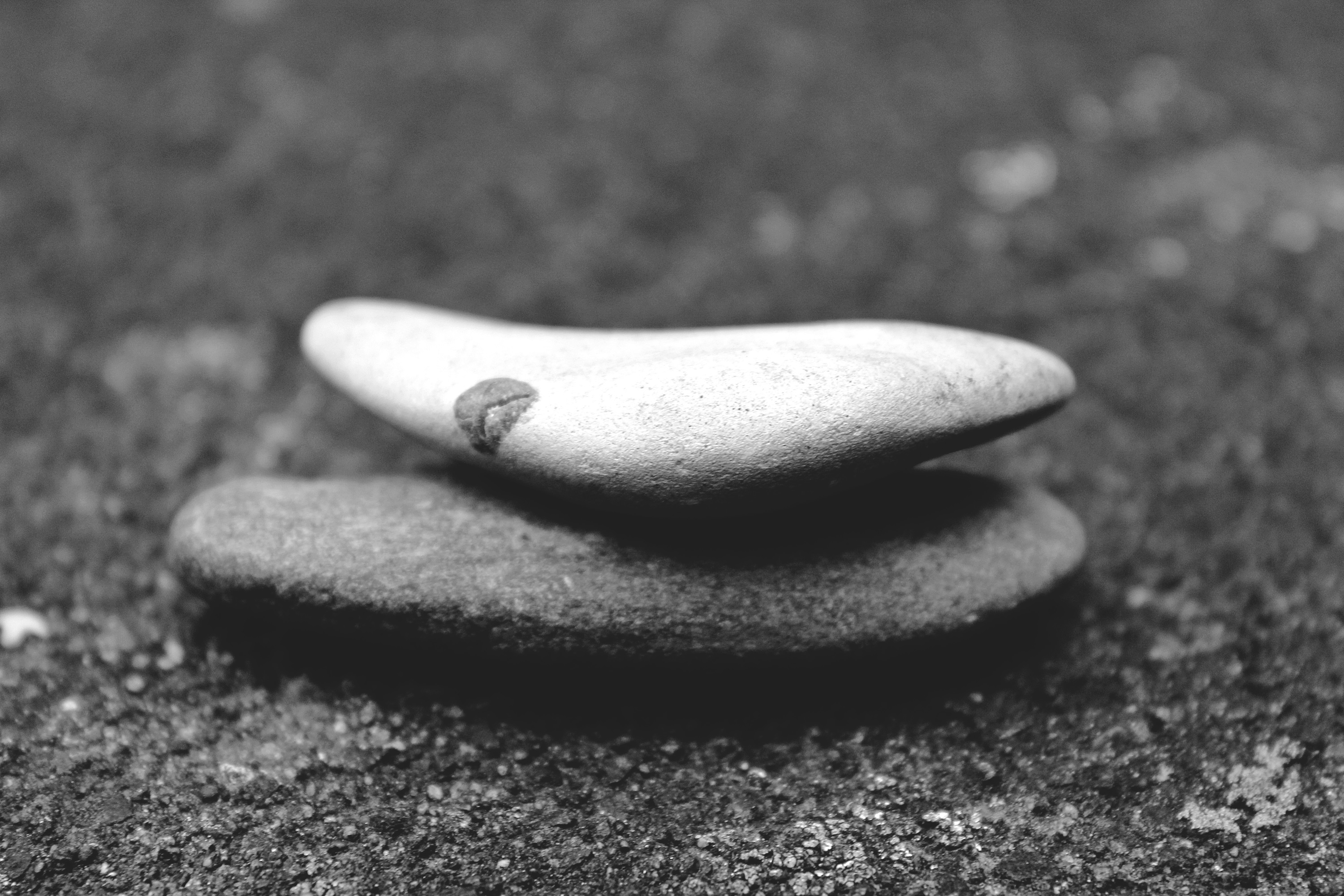 inner peace two stacked stones on sand, symbolizing balance