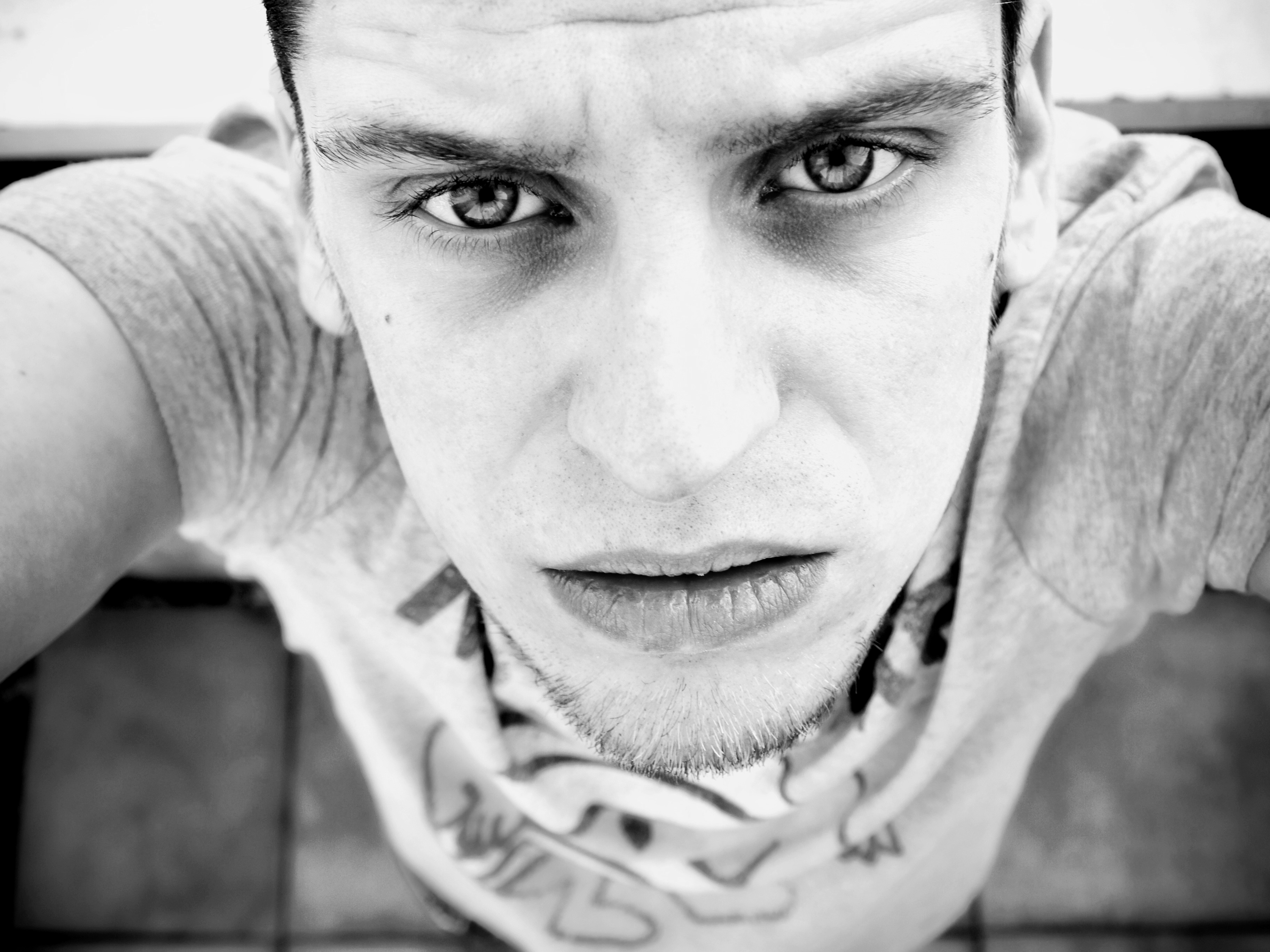 young man looking directly at the camera with an intense, focused expression. self narrative